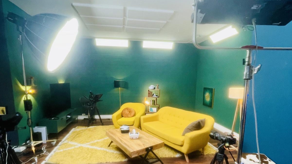Camera and lighting equipment in the TURN ON studio with the yellow sofa corner in the background