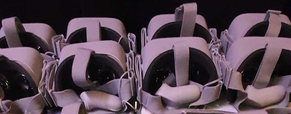 Stacked VR headsets laid out before a screening